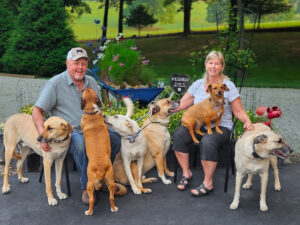 Owners JD and Caroline with their dogs outside Tranquil Tides Pet Aquamation in Nixa, MO.