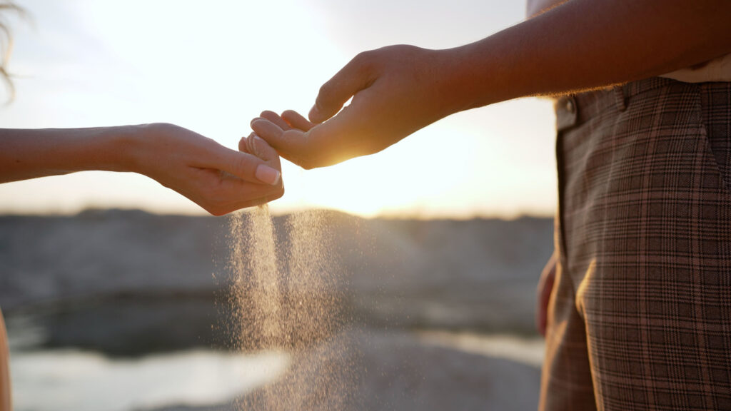 Hands scattering pet ashes