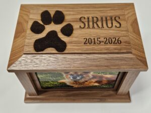 Personalized pet cremation photograph urn with actual paw print engraving for individual care.