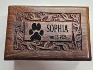 Close-up of actual paw print laser-engraved on rosewood urn for Springfield and Branson families